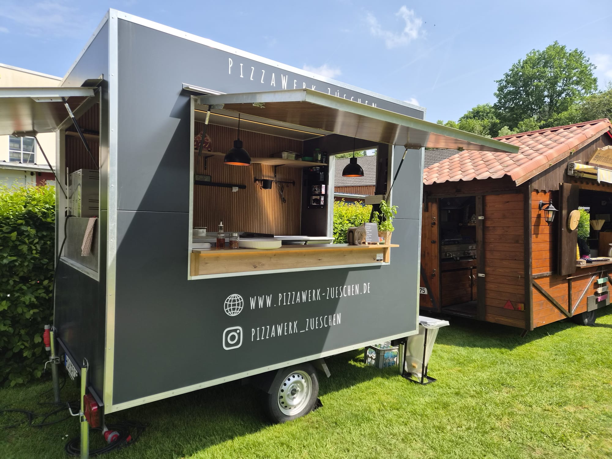 PizzaWerk mobile pizza trailer at sunny event